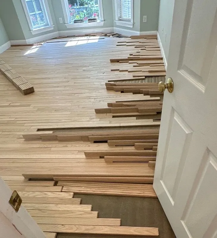 Hardwood floor being installed in a bay window room with beautiful stagger pattern