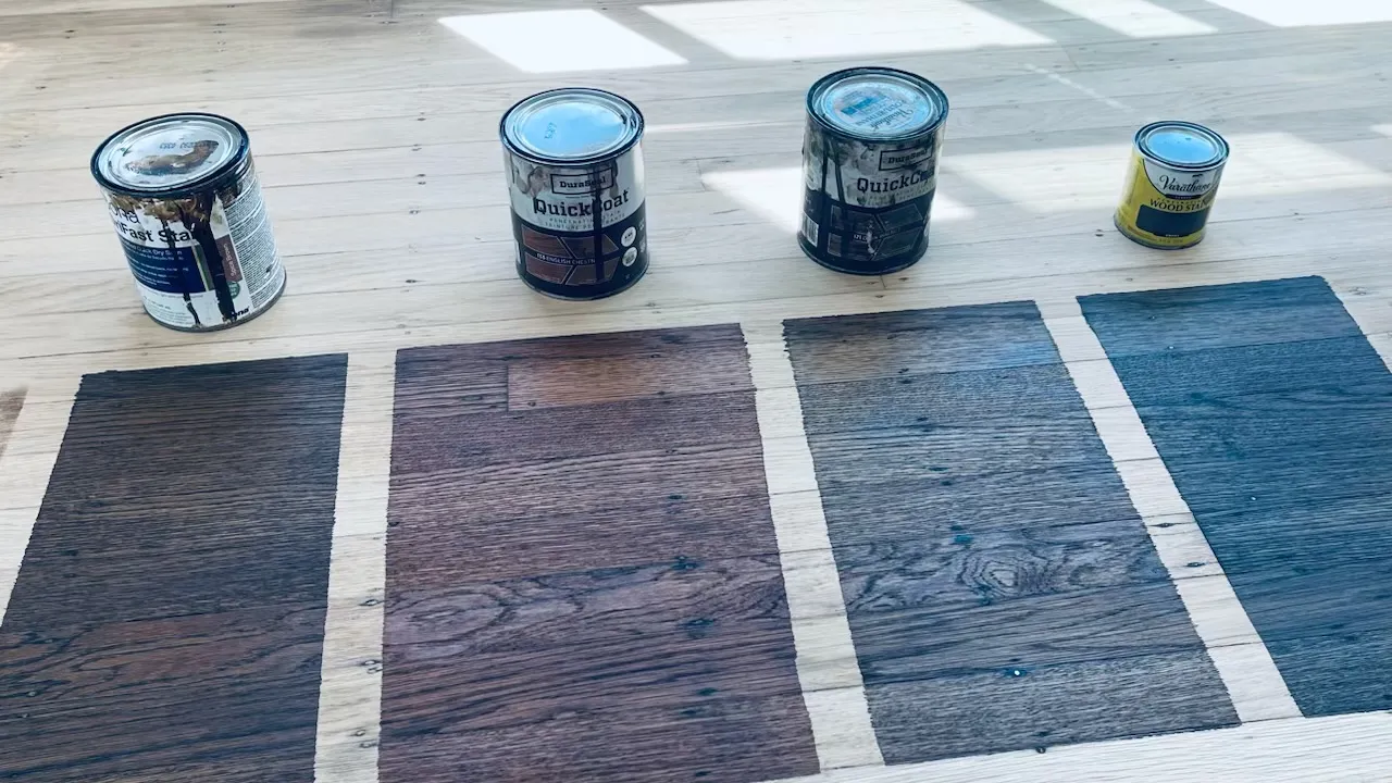 Four stain color samples applied to raw hardwood floor with QuickCoat cans